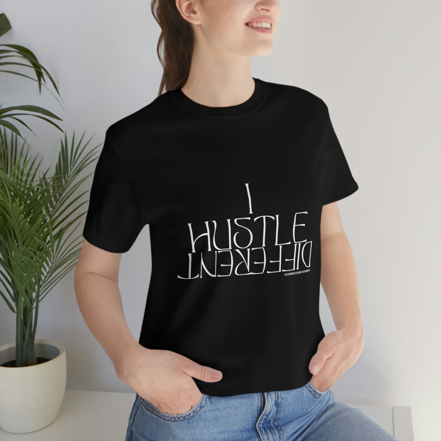 Woman Entrepreneur wearing "I Hustle DIFFERENT" Black T-Shirt with blue jeans