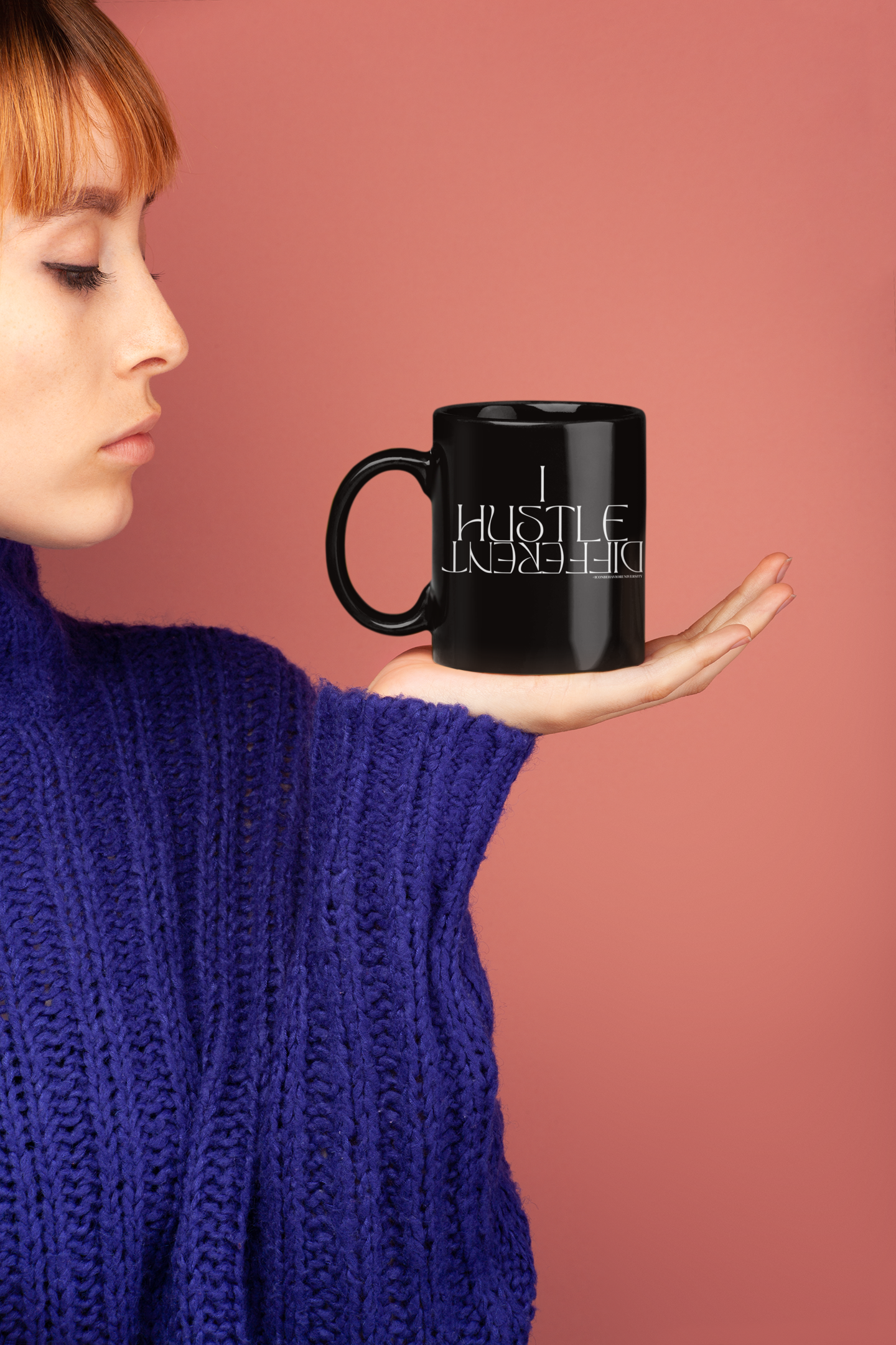 I Hustle Different Black Mug held by red head women in purple sweater 